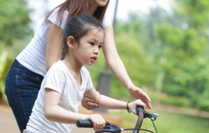 Child Learning to Ride a Bike